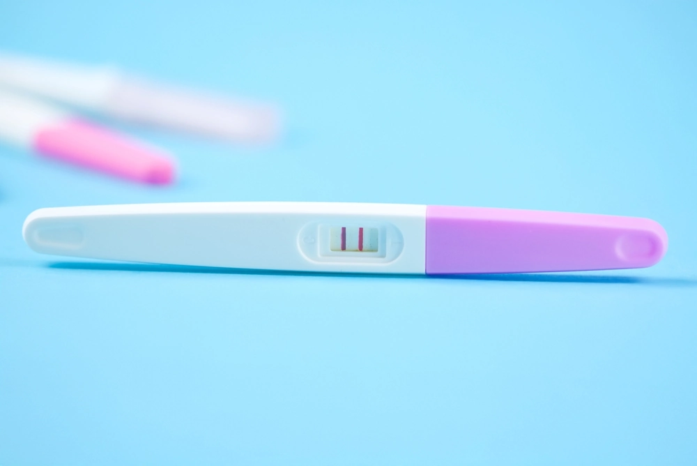 Positive pregnancy test, family planning with medical support. The topic of IVF, health and a conscious approach to motherhood. High quality photo